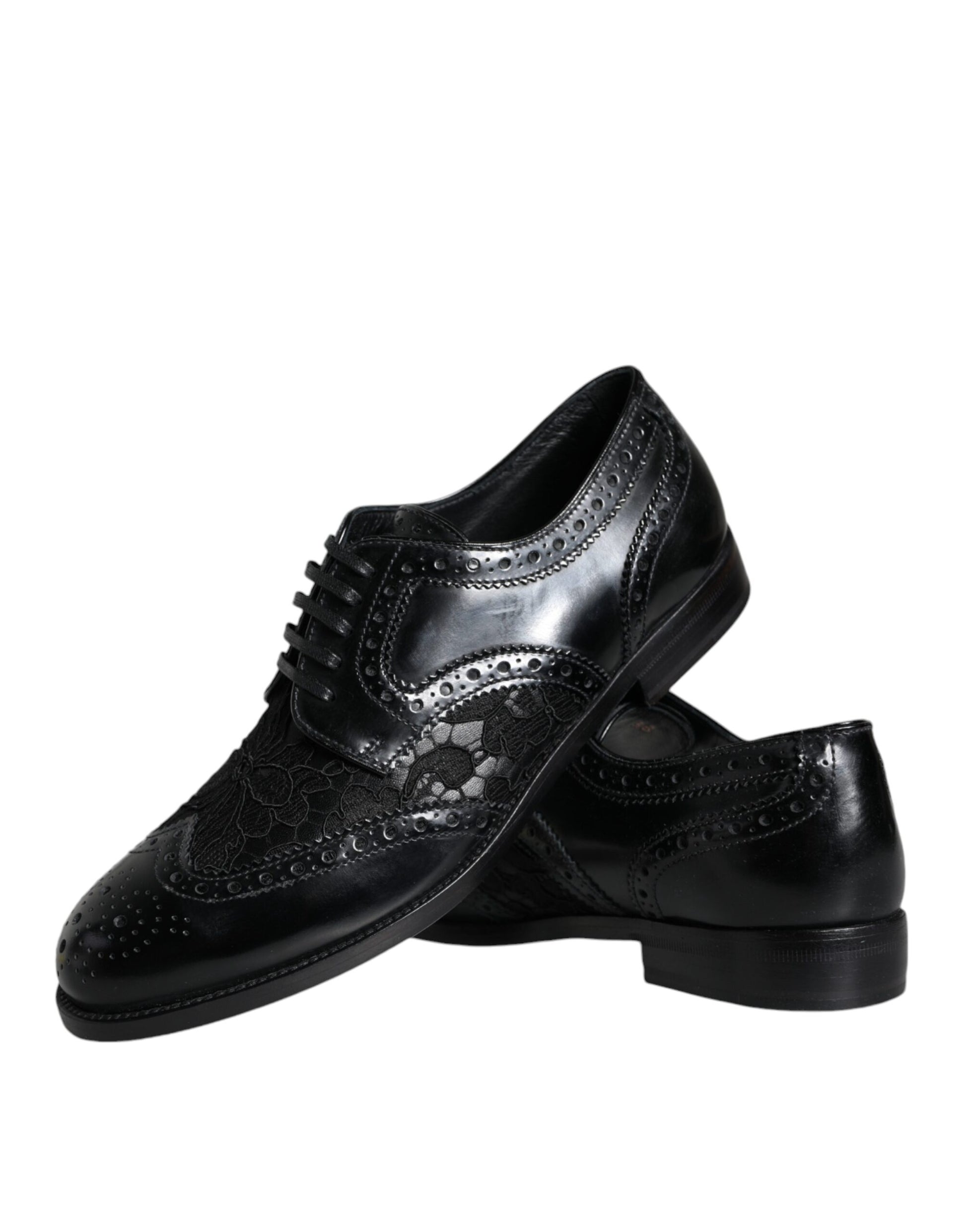 Pair of black leather dress shoes with floral lace design and silver buckle