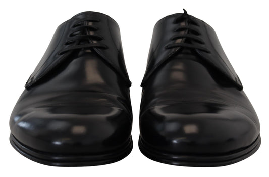 Pair of black dress shoes with laces and a shiny finish