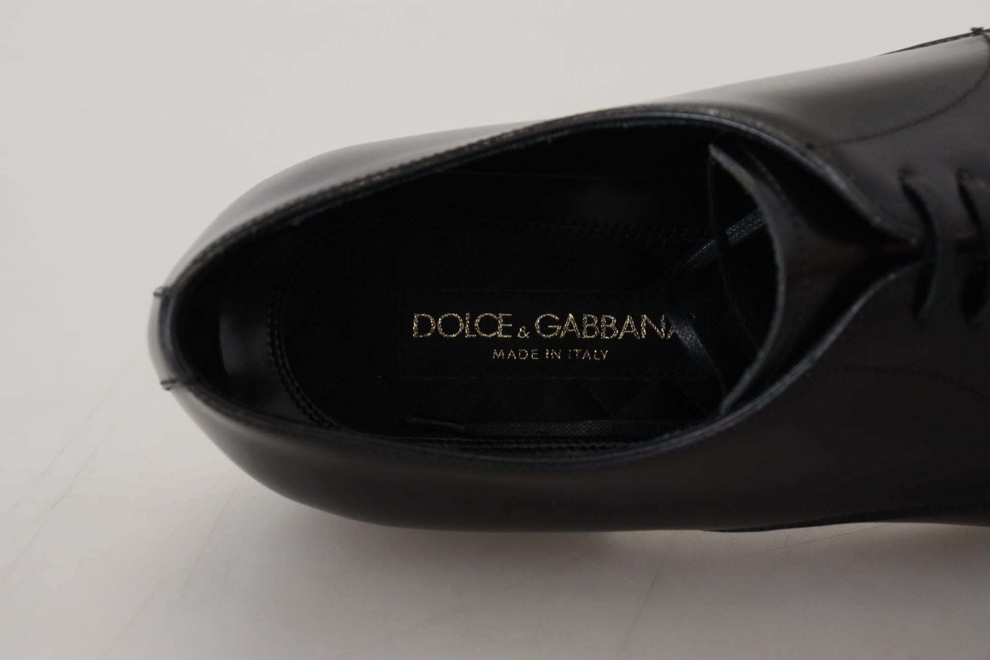 Black shoe with gold branding