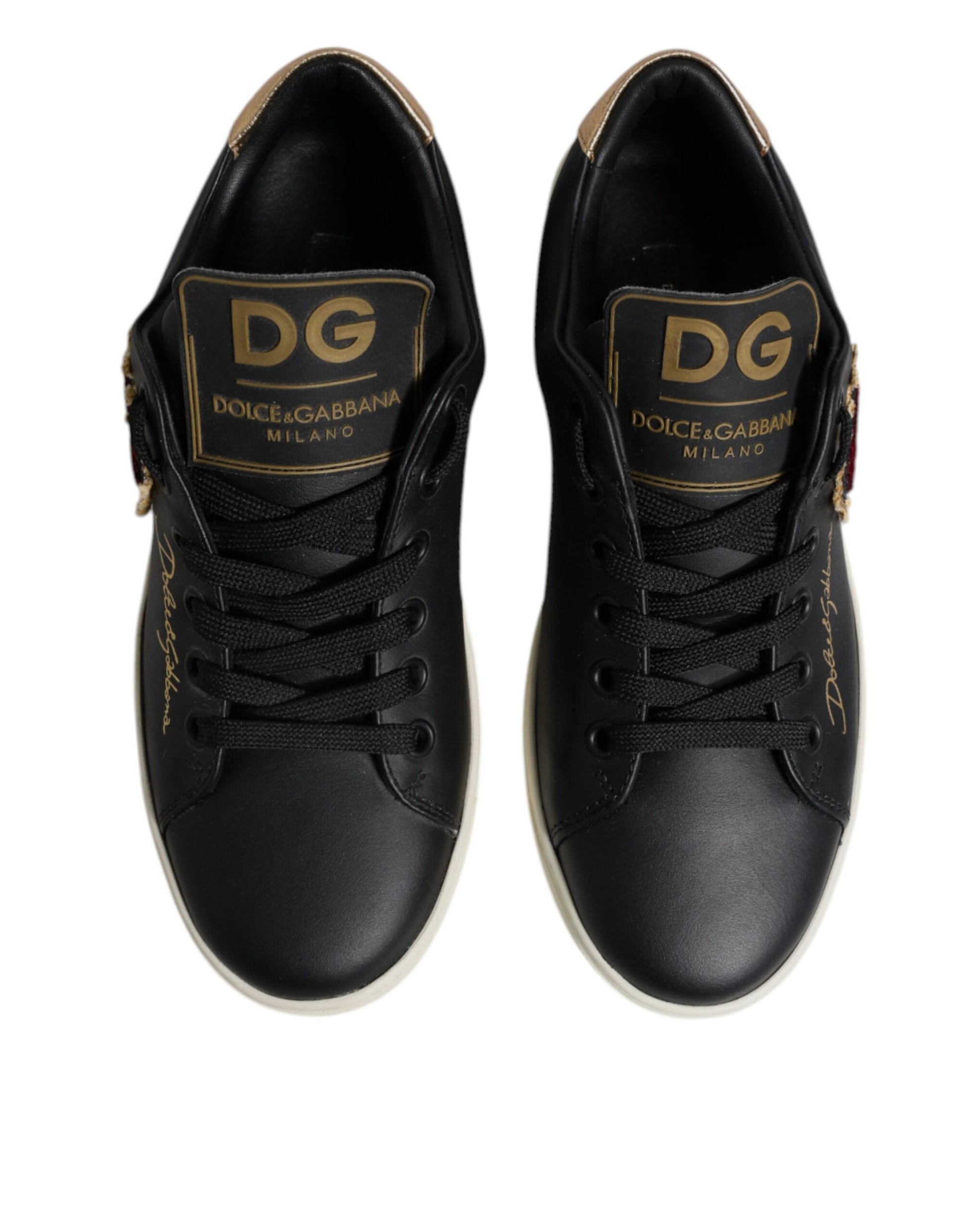 Pair of black sneakers with gold branding