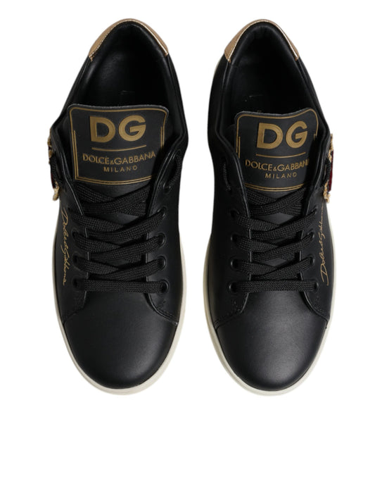Pair of black sneakers with gold branding