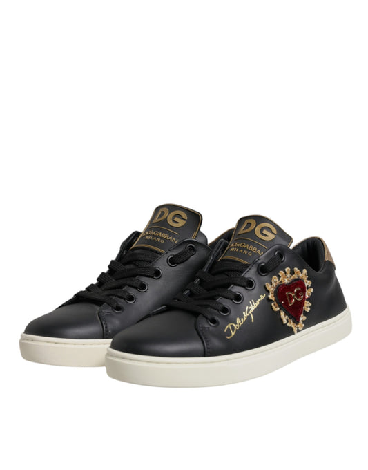 Black sneakers with gold accents and a heart design on the side