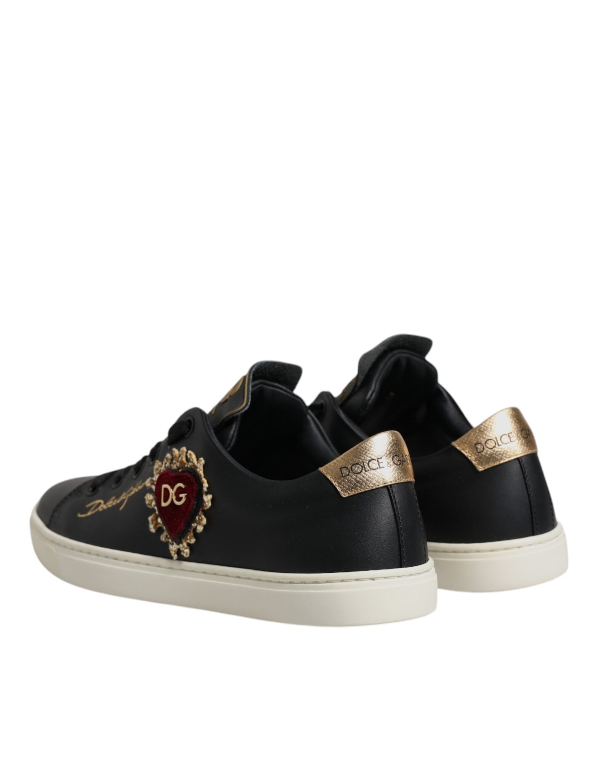 Black sneakers with gold accents and a heart design on the side