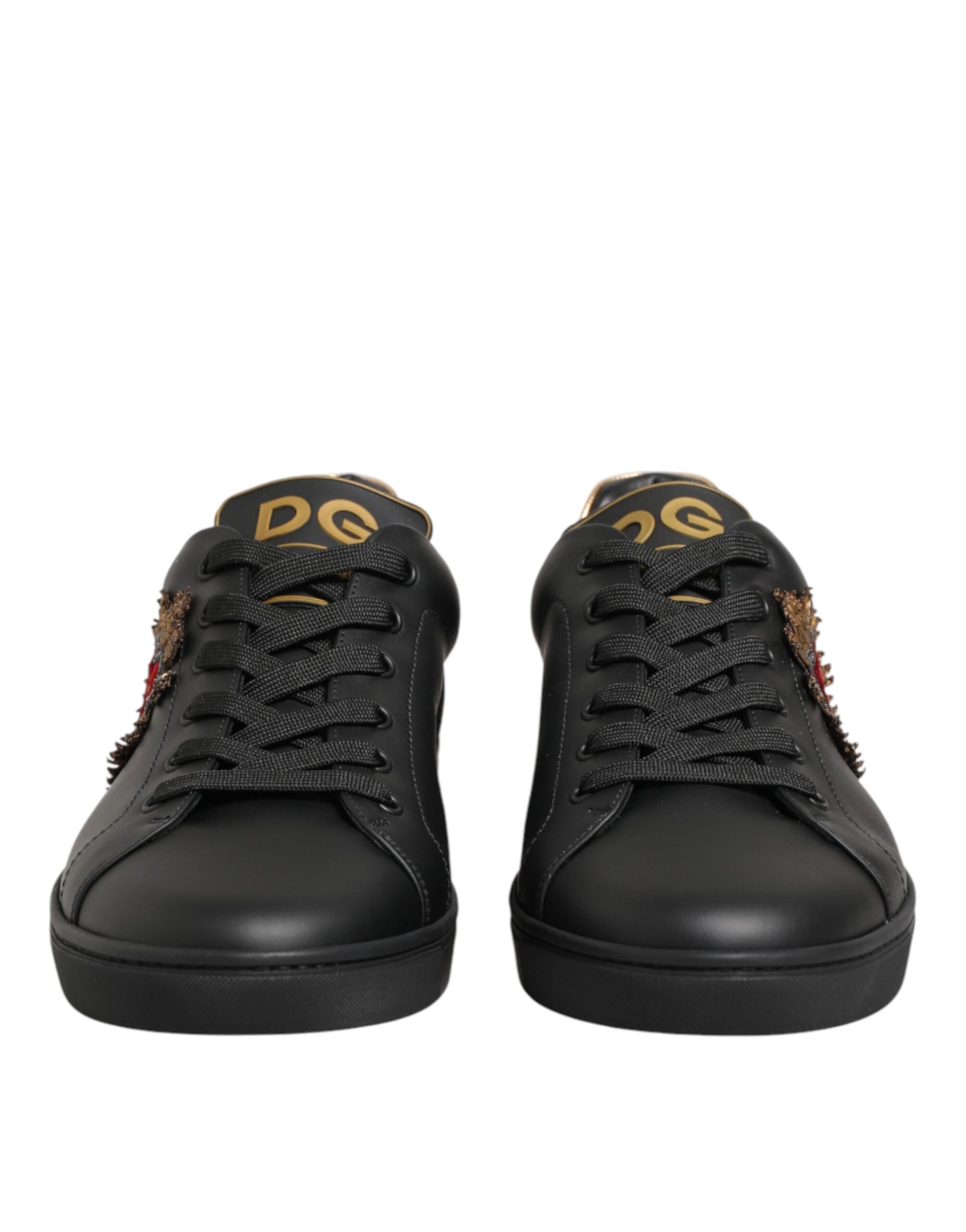 Pair of black sneakers with gold accents