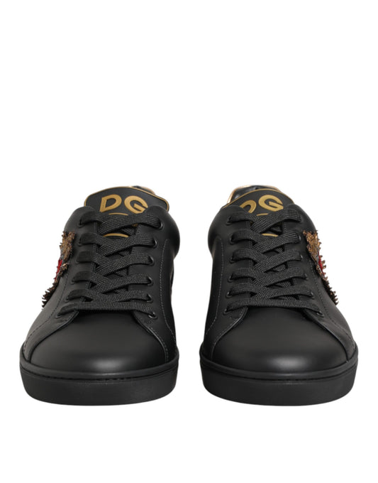 Pair of black sneakers with gold accents