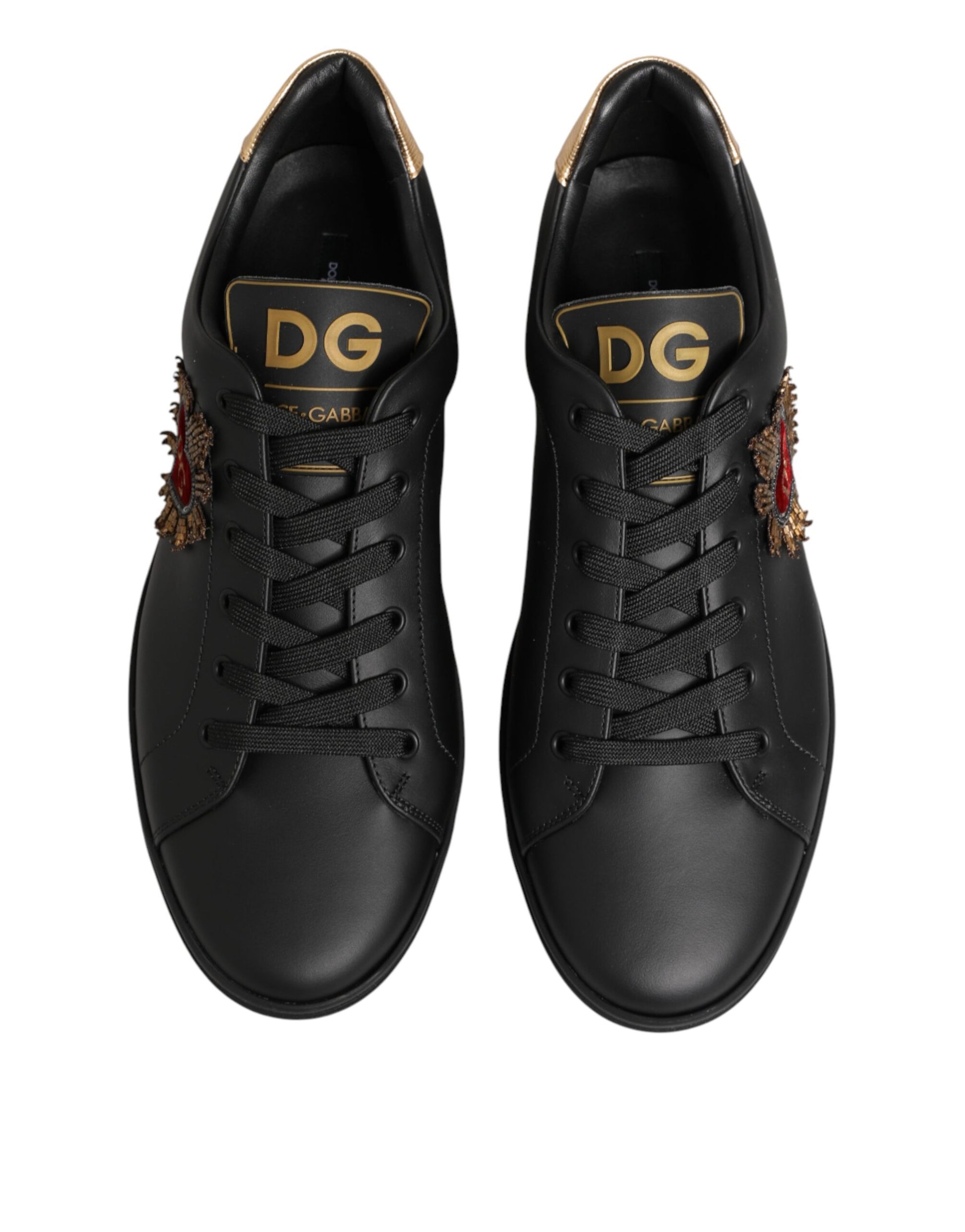 Pair of black sneakers with gold lettering on side
