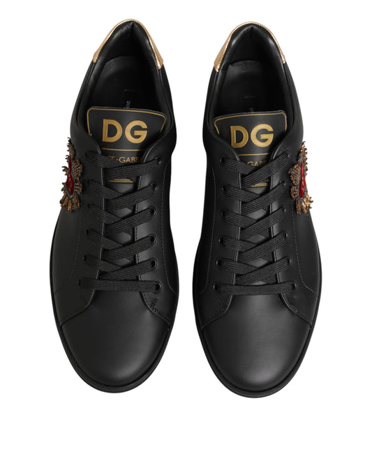 Pair of black sneakers with gold lettering on side