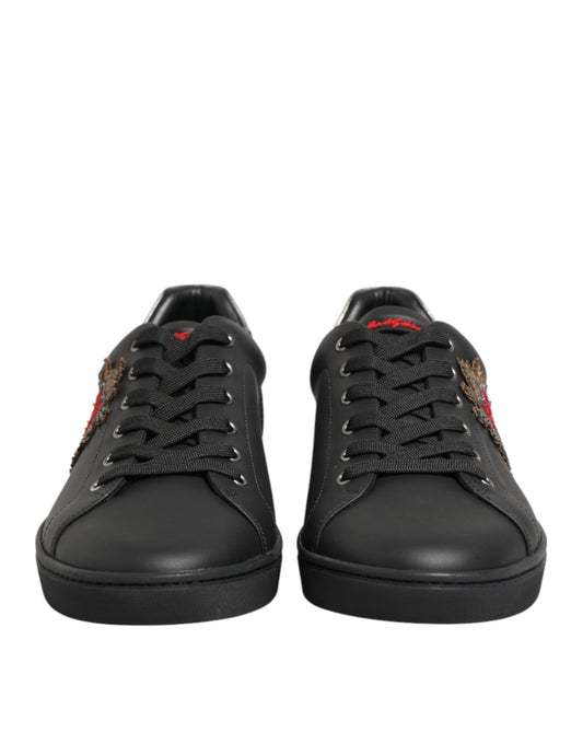 Pair of black sneakers with red logo on side