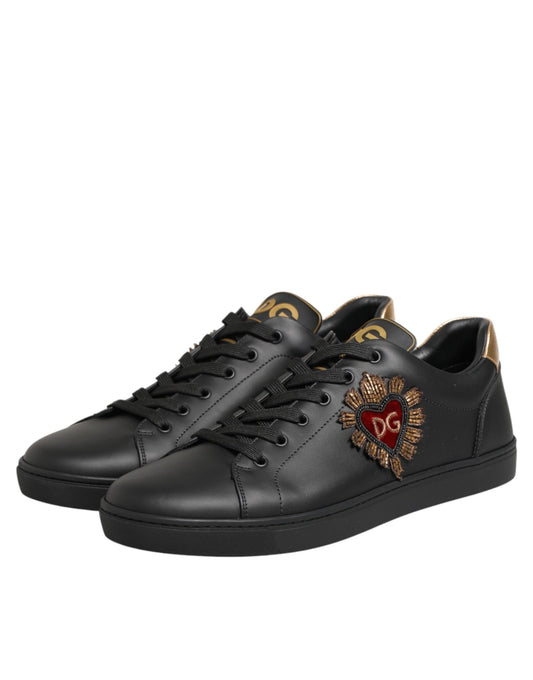 Black sneakers with gold accents and a heart design on the side