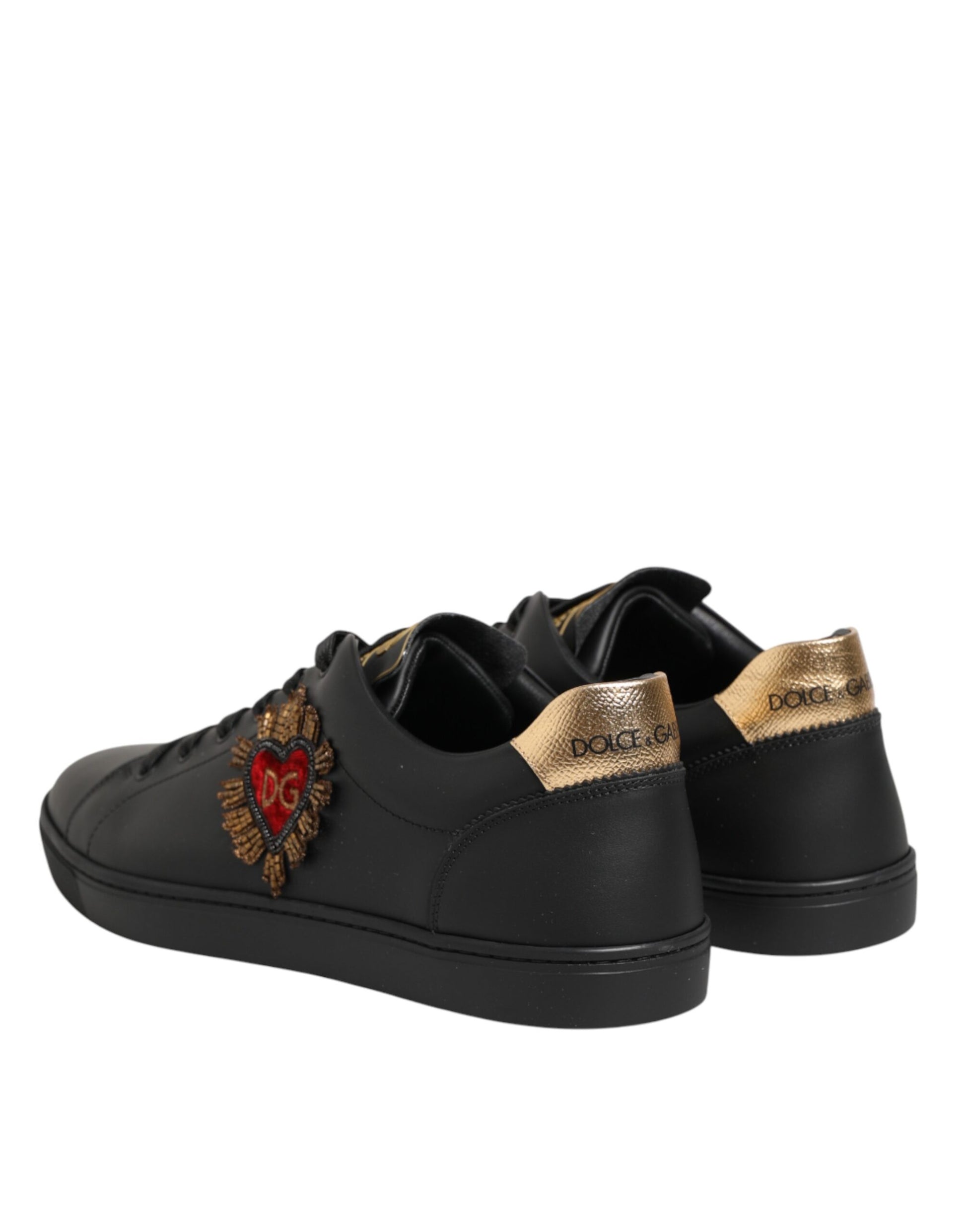 Pair of black sneakers with gold accents and a heart design on the side