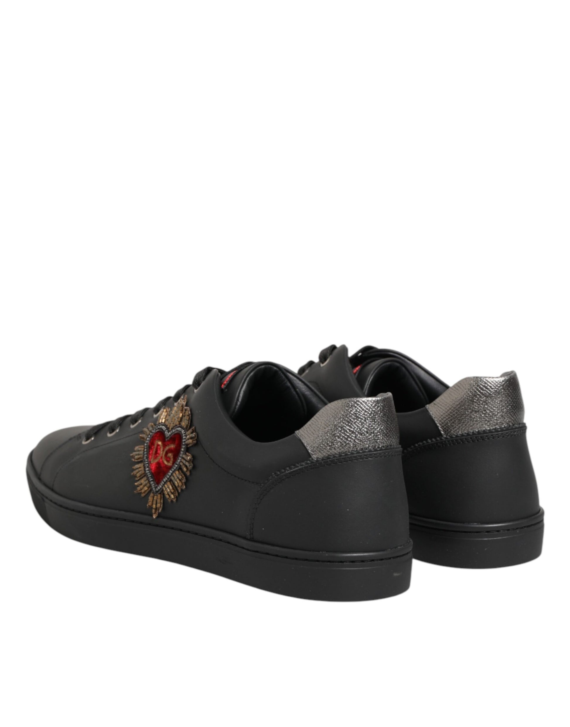Pair of black sneakers with heart embroidery on side