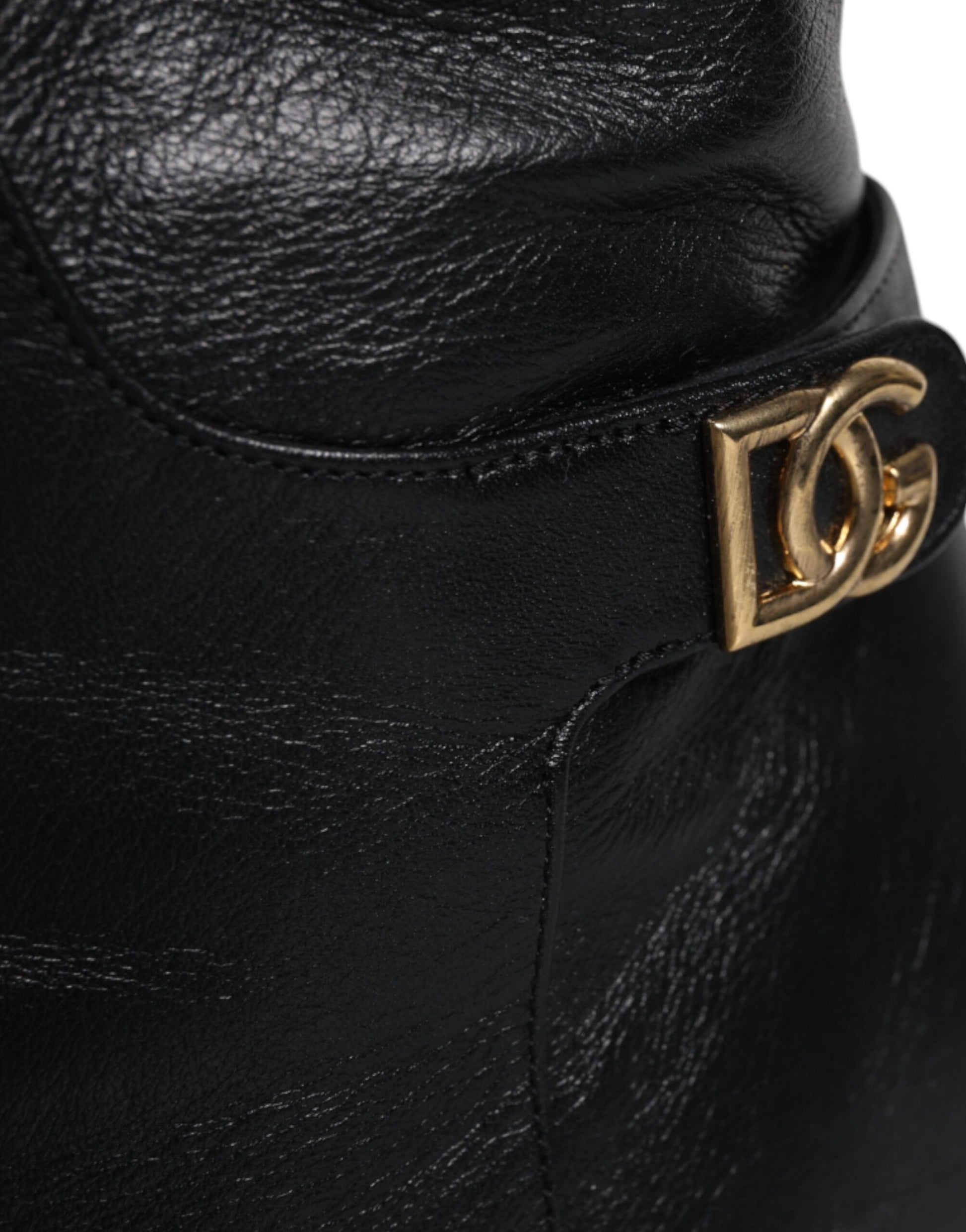 Black leather boot with gold buckle