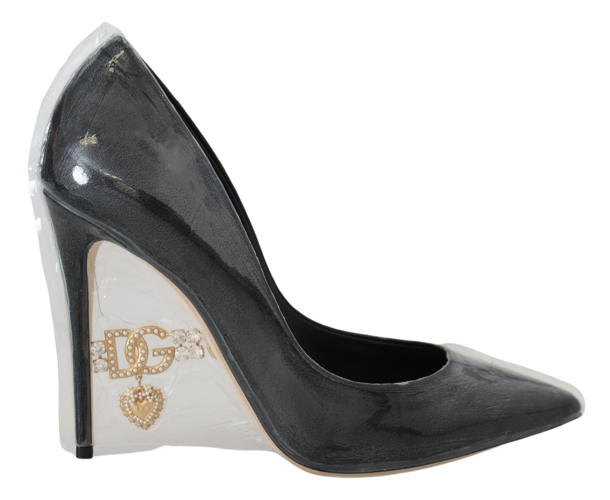 Black high heel shoe with gold accents and a bow on the toe
