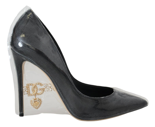 Black high heel shoe with gold accents and a bow on the toe