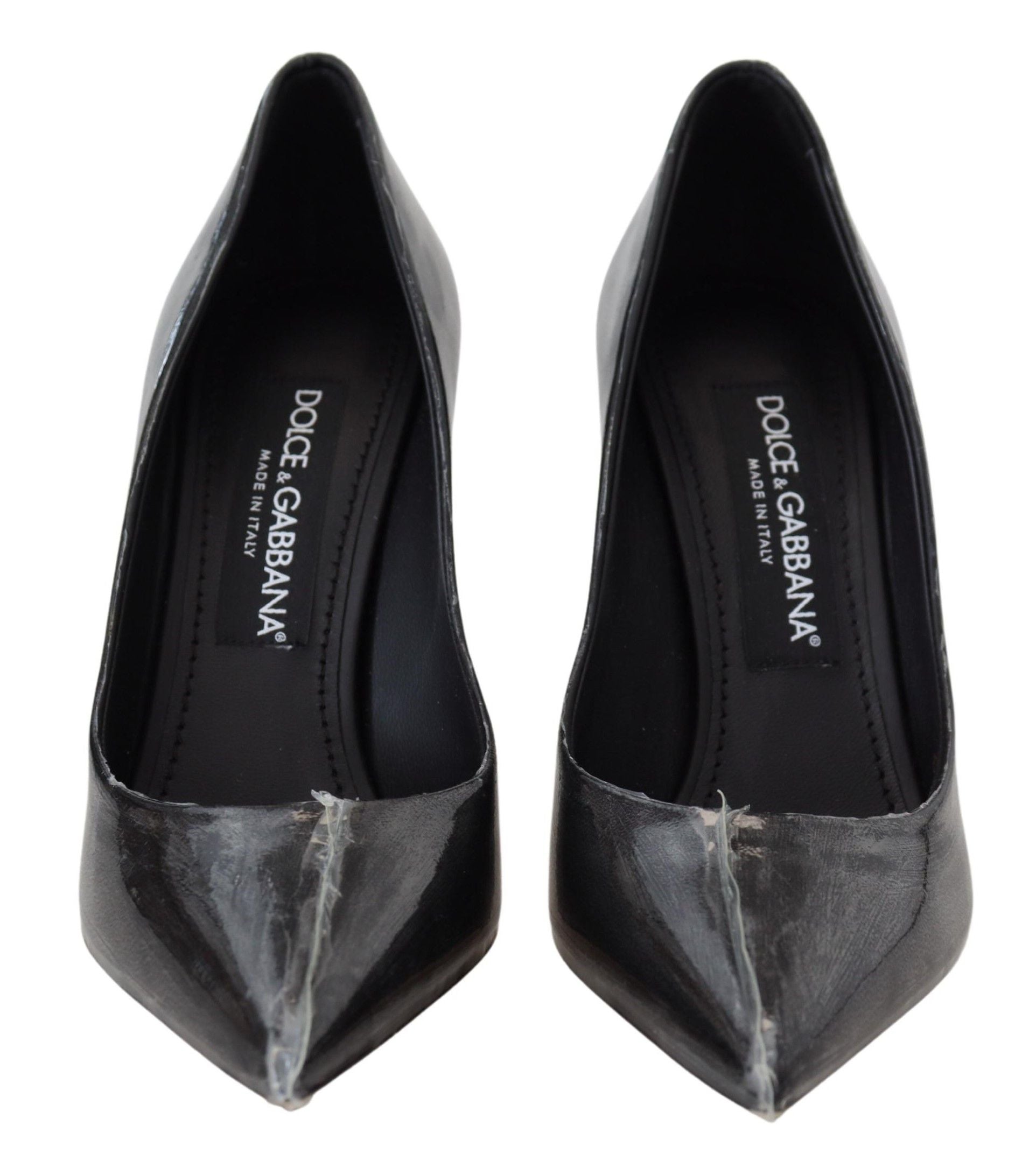 Pair of black high heel shoes with a pointed toe and a strap across the foot