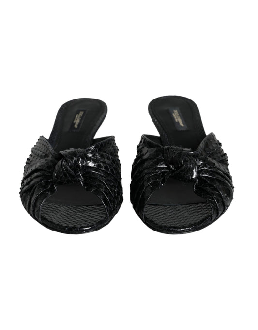 Pair of black glittery women's sandals with bow detailing