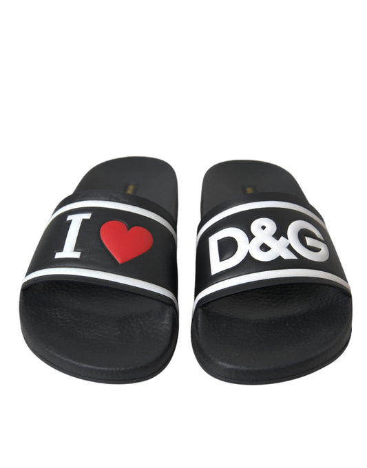 Pair of black flip flops with white lettering