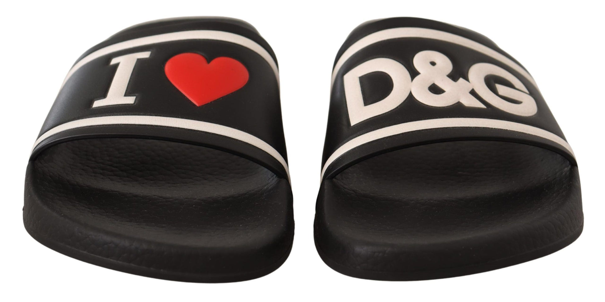 Pair of black flip flops with white lettering and heart design