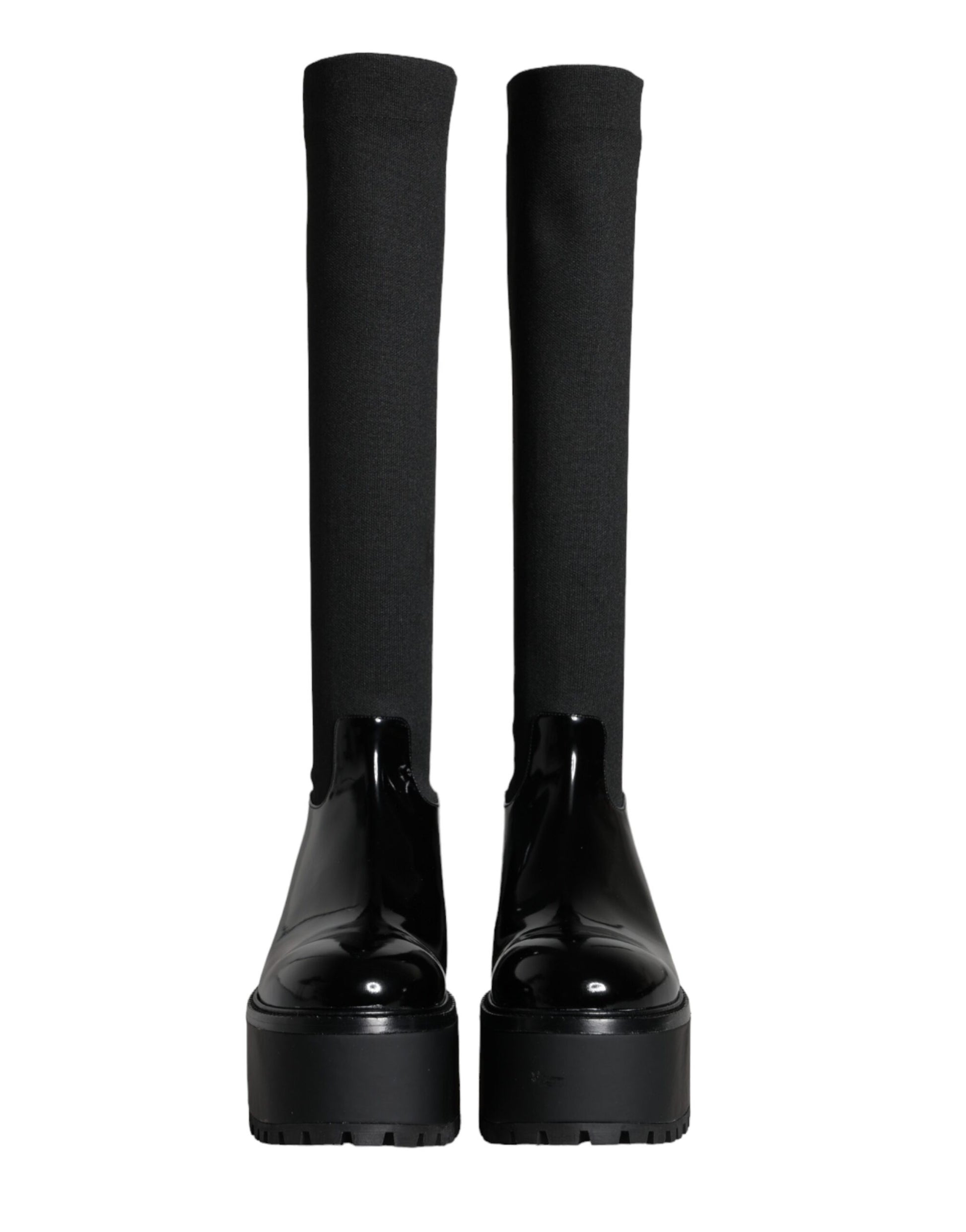 Pair of black knee high boots with chunky heels