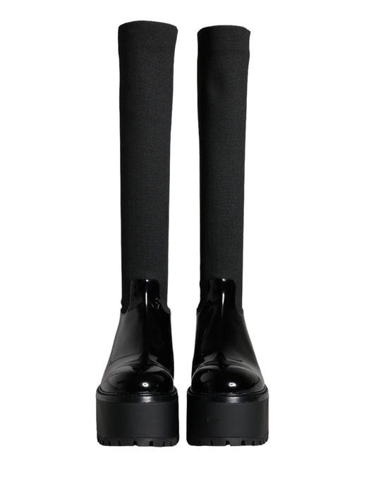 Pair of black knee high boots with chunky heels
