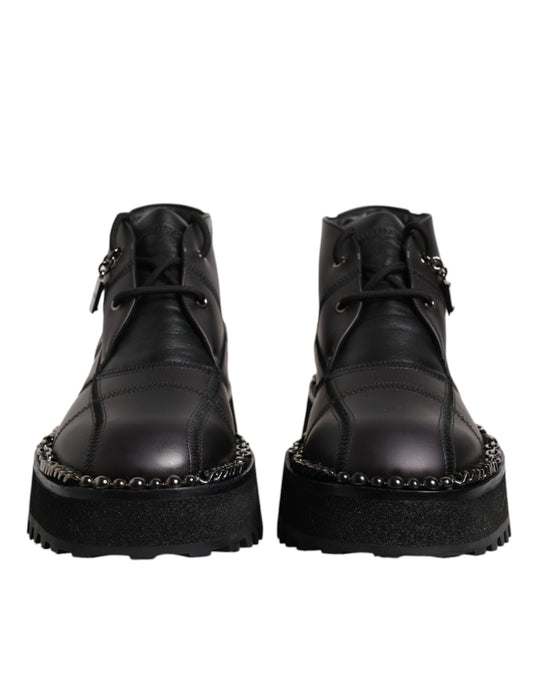 Pair of black leather boots with silver studs on sides
