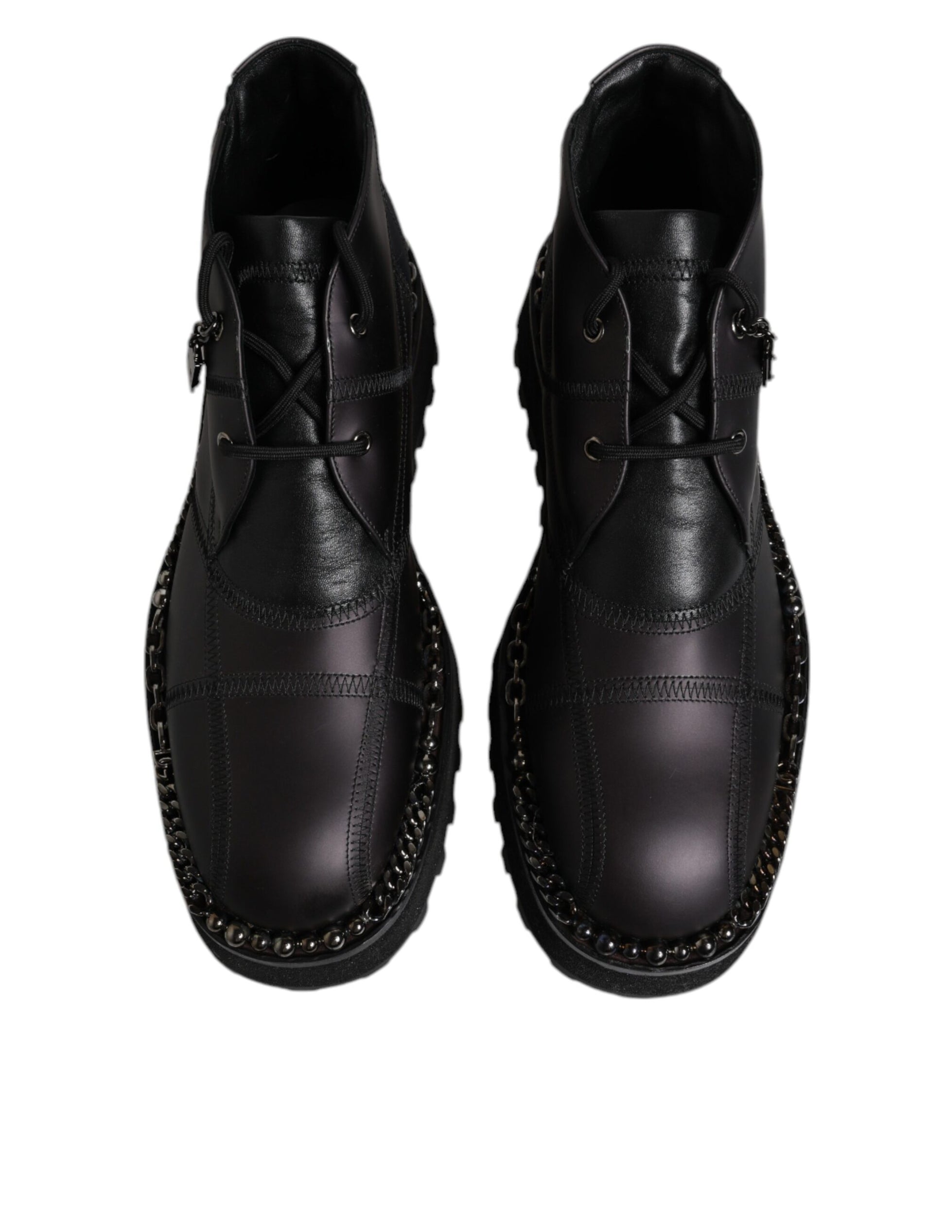 Pair of black leather shoes with laces and studs on sides