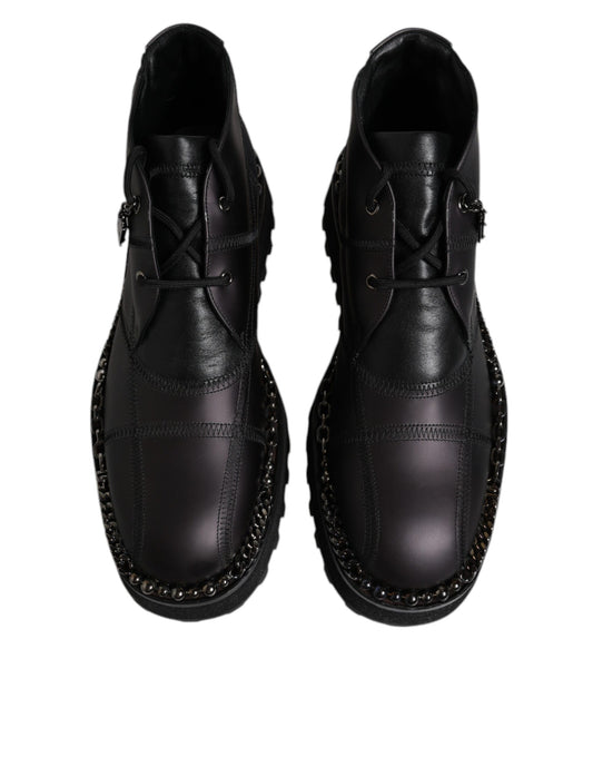 Pair of black leather shoes with laces and studs on sides