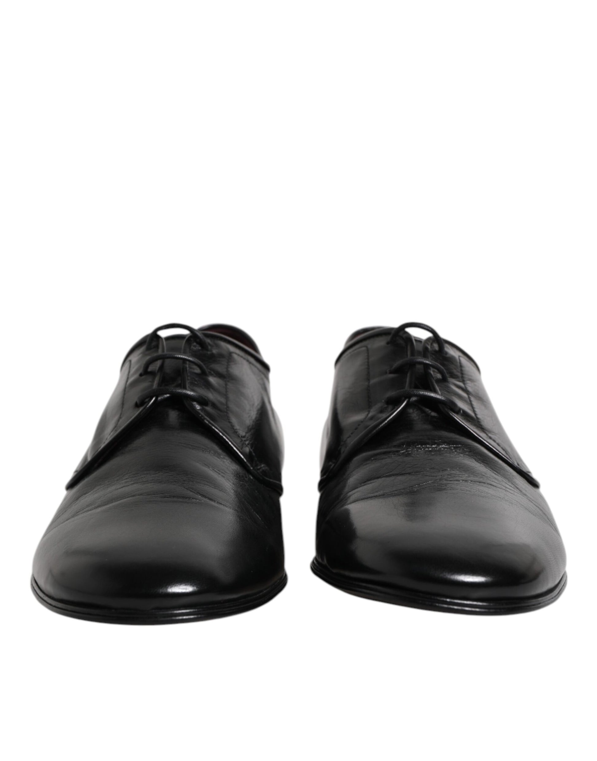 Pair of black leather lace-up dress shoes with silver eyelets and a shiny finish