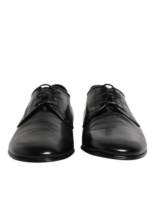Pair of black leather lace-up dress shoes with silver eyelets and a shiny finish