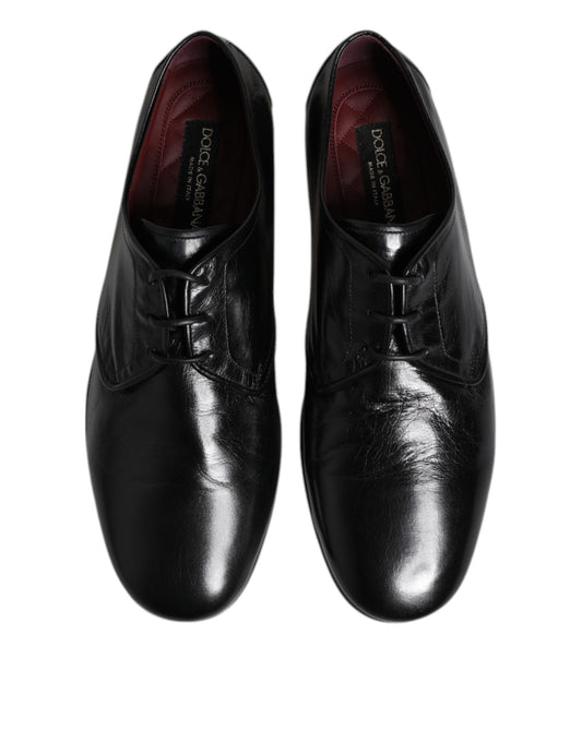 Pair of black leather lace-up dress shoes with silver buckles