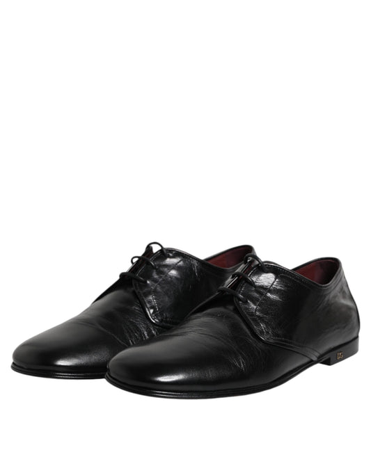 Pair of black leather lace-up dress shoes with a shiny finish