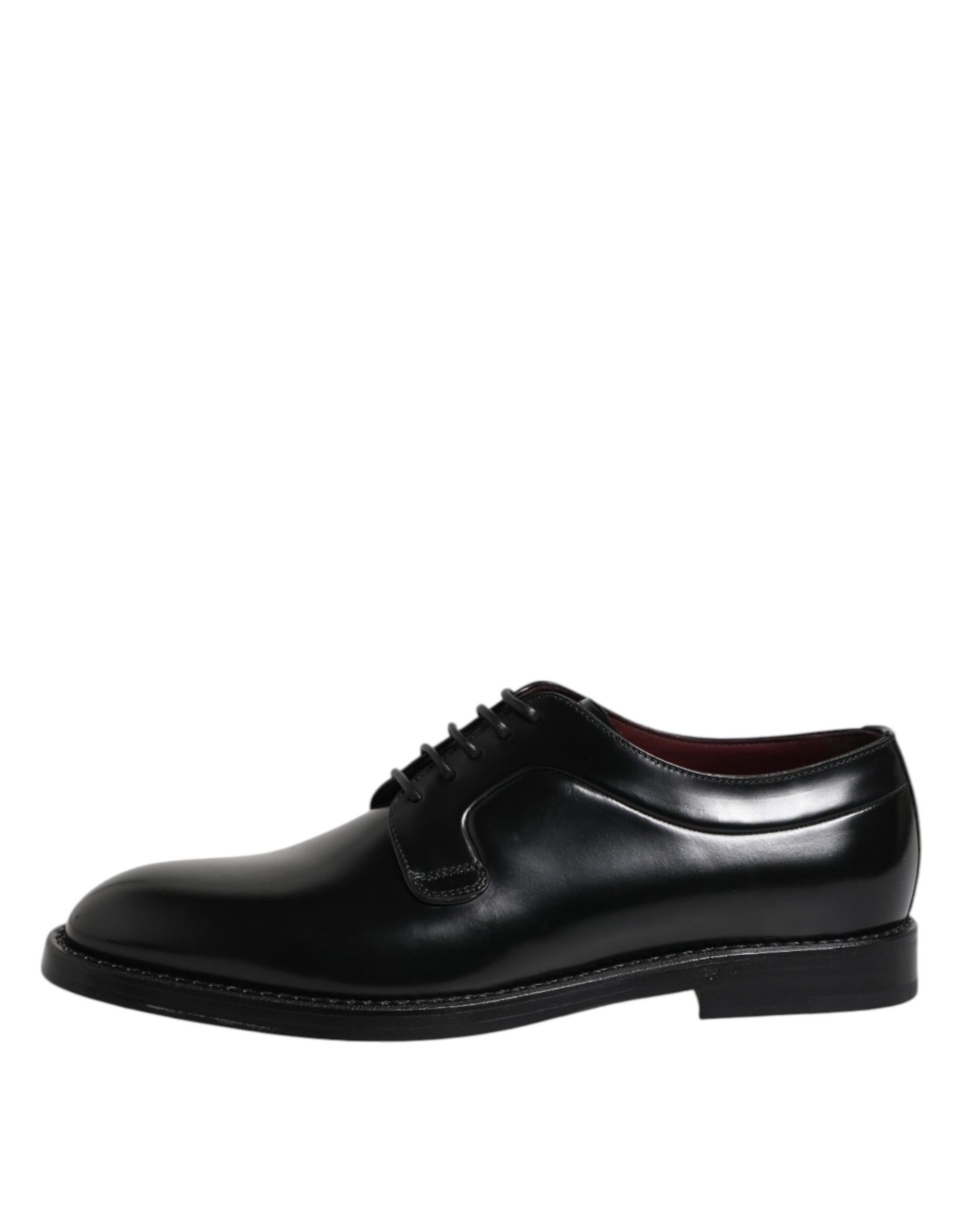 A pair of black leather lace-up dress shoes with a red sole, designed by Dolce & Gabbana