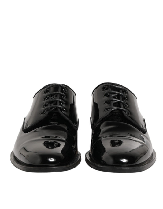 Pair of black leather lace-up dress shoes with a shiny finish