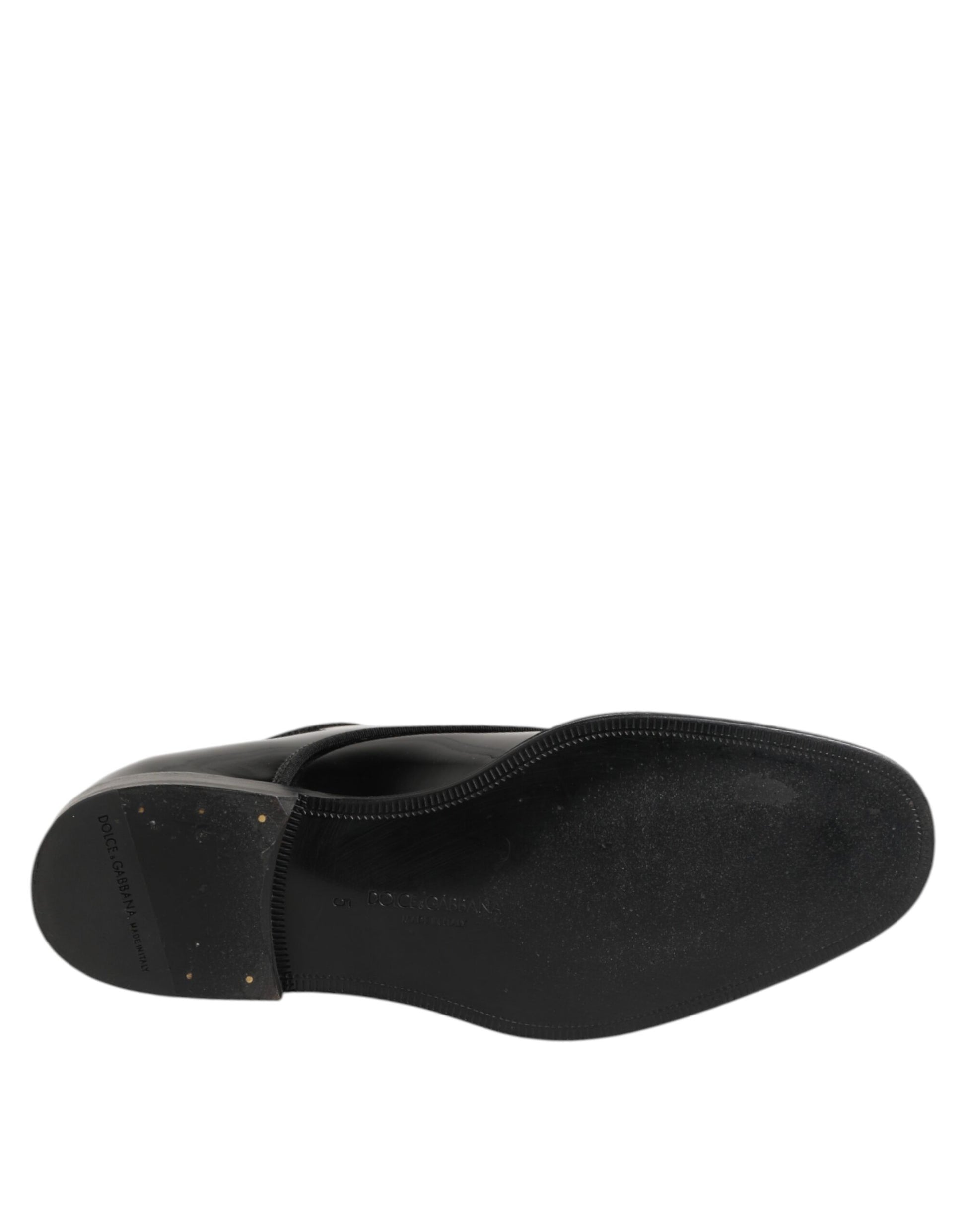 A pair of black leather lace-up dress shoes with a textured surface