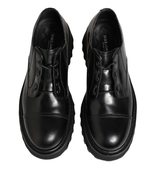 Pair of black leather lace-up dress shoes with a shiny finish, featuring a derby style design
