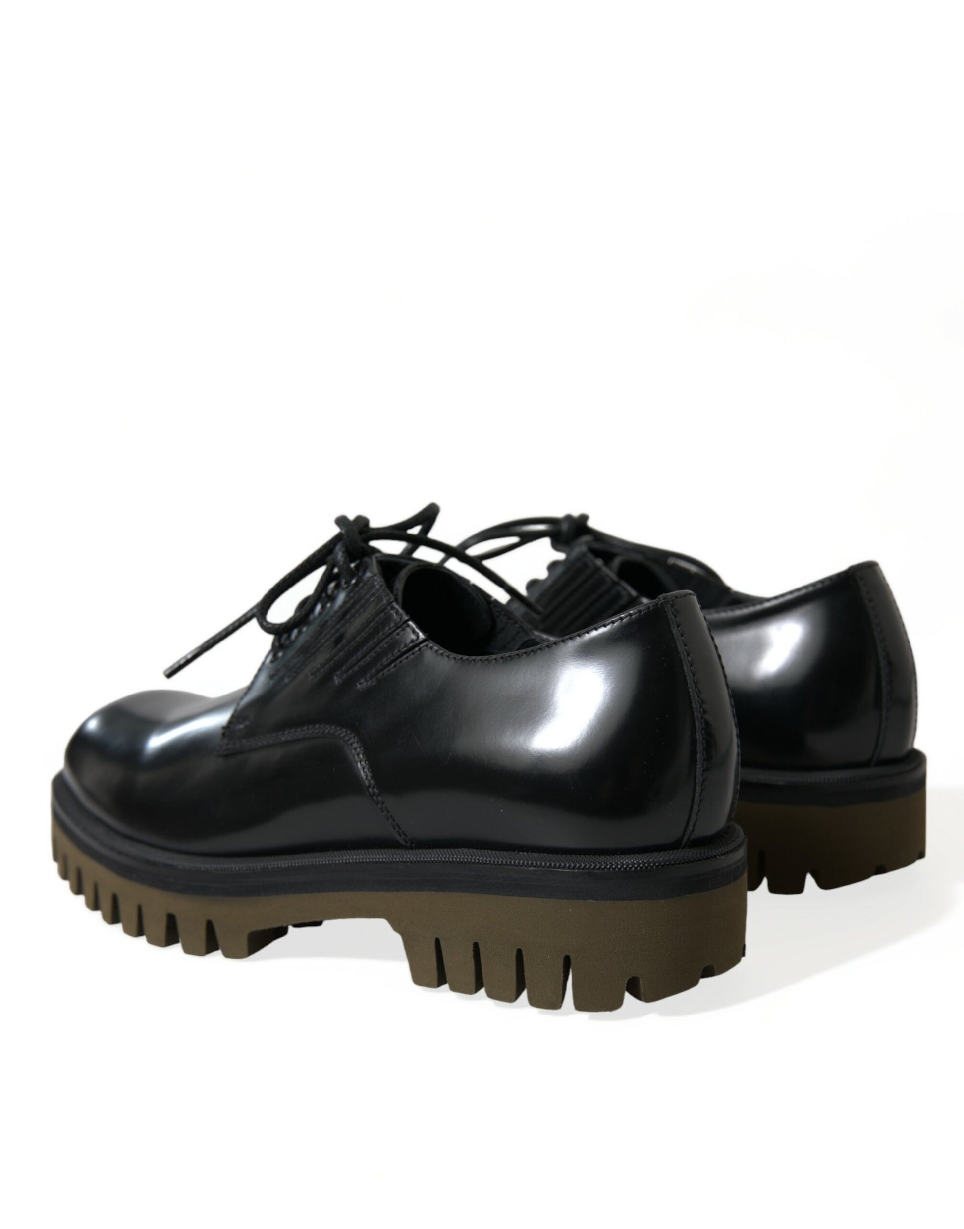Pair of black leather shoes with brown soles and laces