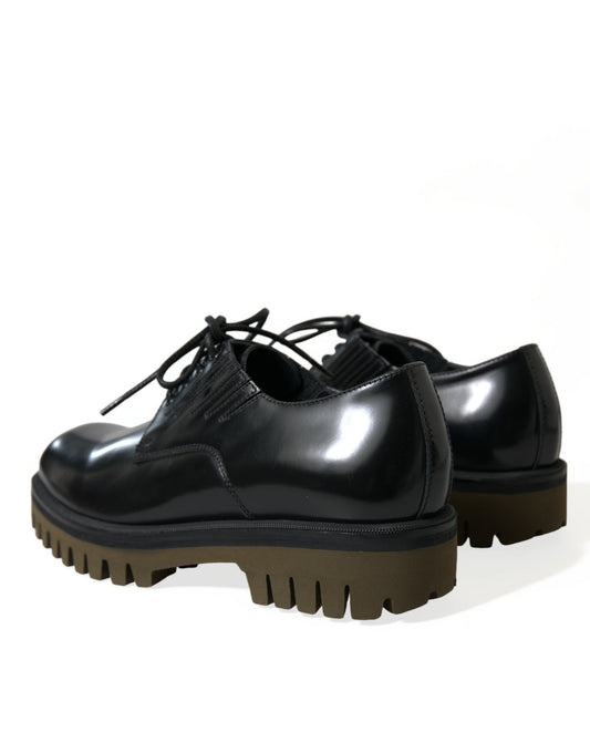 Pair of black leather shoes with brown soles and laces