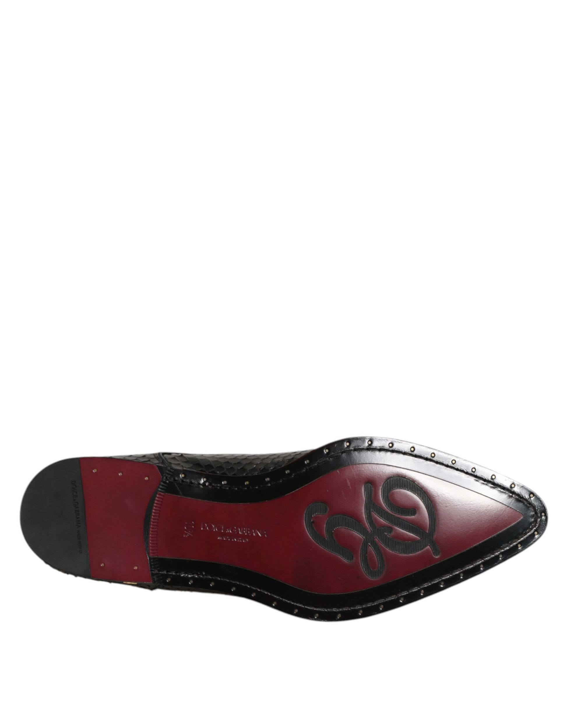 A single black leather lace-up shoe with a red sole, featuring the Dolce & Gabbana logo