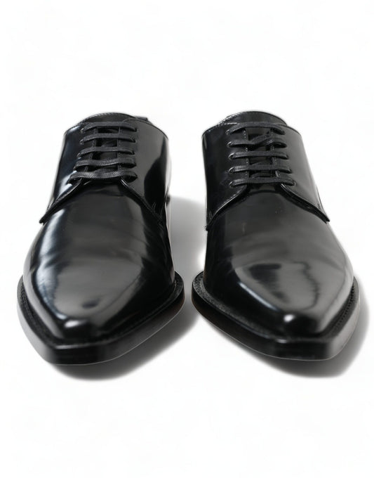 Pair of black dress shoes with laces and a shiny finish