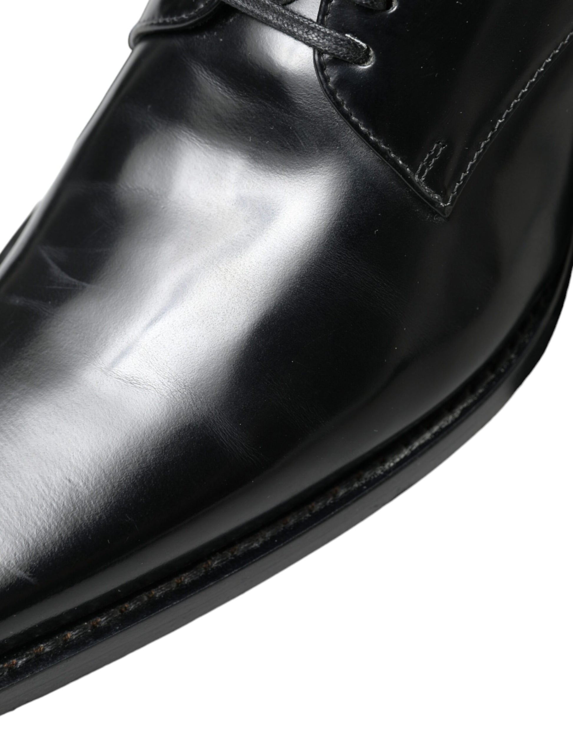 Black leather dress shoe with laces and a polished toe