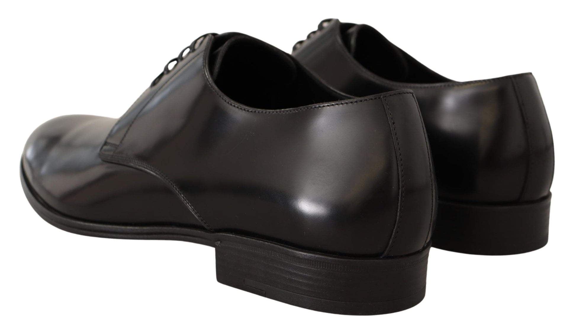Pair of black dress shoes with laces and a shiny finish
