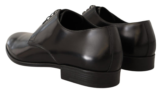 Pair of black dress shoes with laces and a shiny finish
