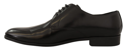 Pair of black dress shoes with laces and a small heel