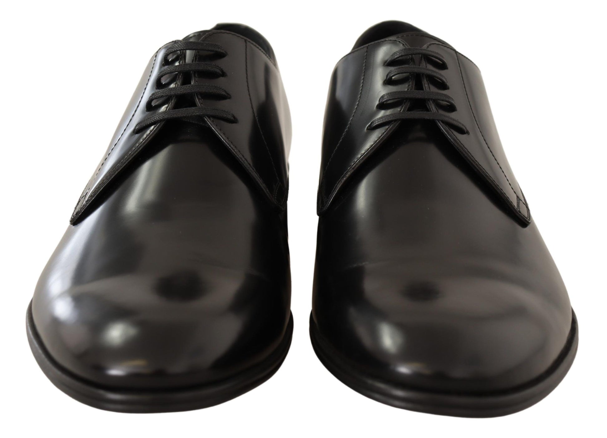 Pair of black dress shoes with laces and a shiny finish