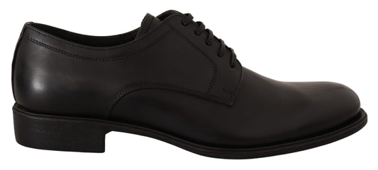 Pair of black dress shoes with laces and a small heel