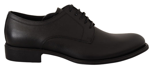 Pair of black leather dress shoes with laces and a small heel