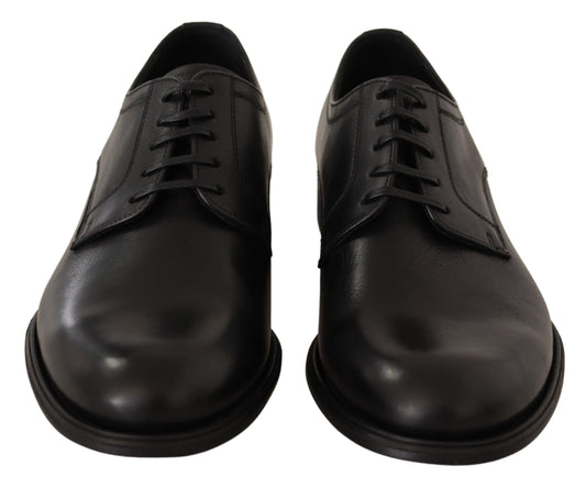 Pair of black leather dress shoes with laces and a strap across the top