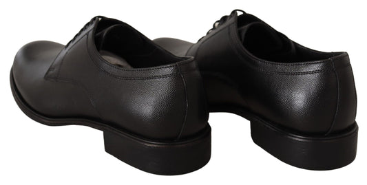 Pair of black leather shoes with laces and a small heel