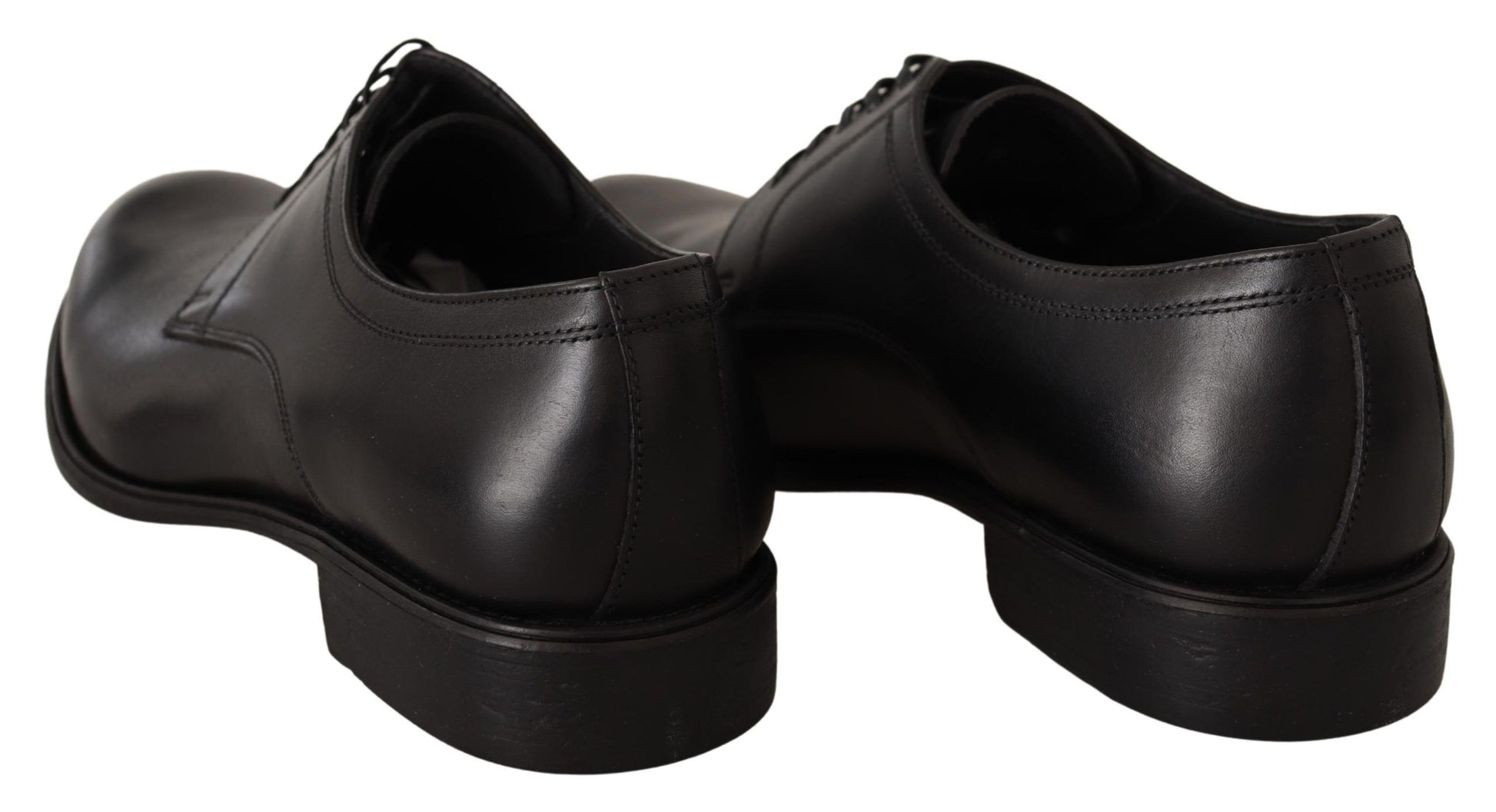 Pair of black dress shoes with laces and a small heel