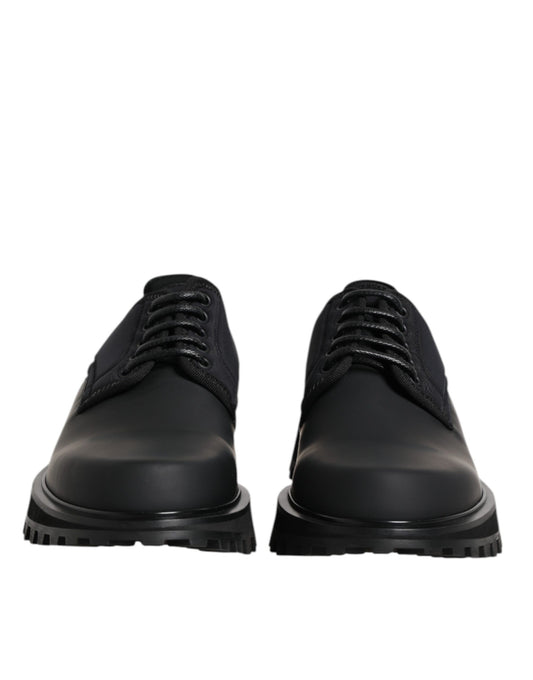 Pair of black leather lace-up shoes with silver eyelets and a low heel
